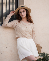 a lady wears a beige crohet crop top and white a-line shorts